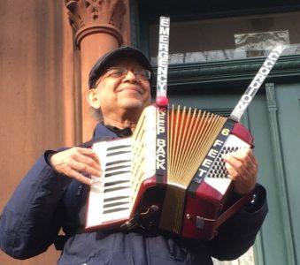 Sunset Park resident provides music by playing accordion on his stoop